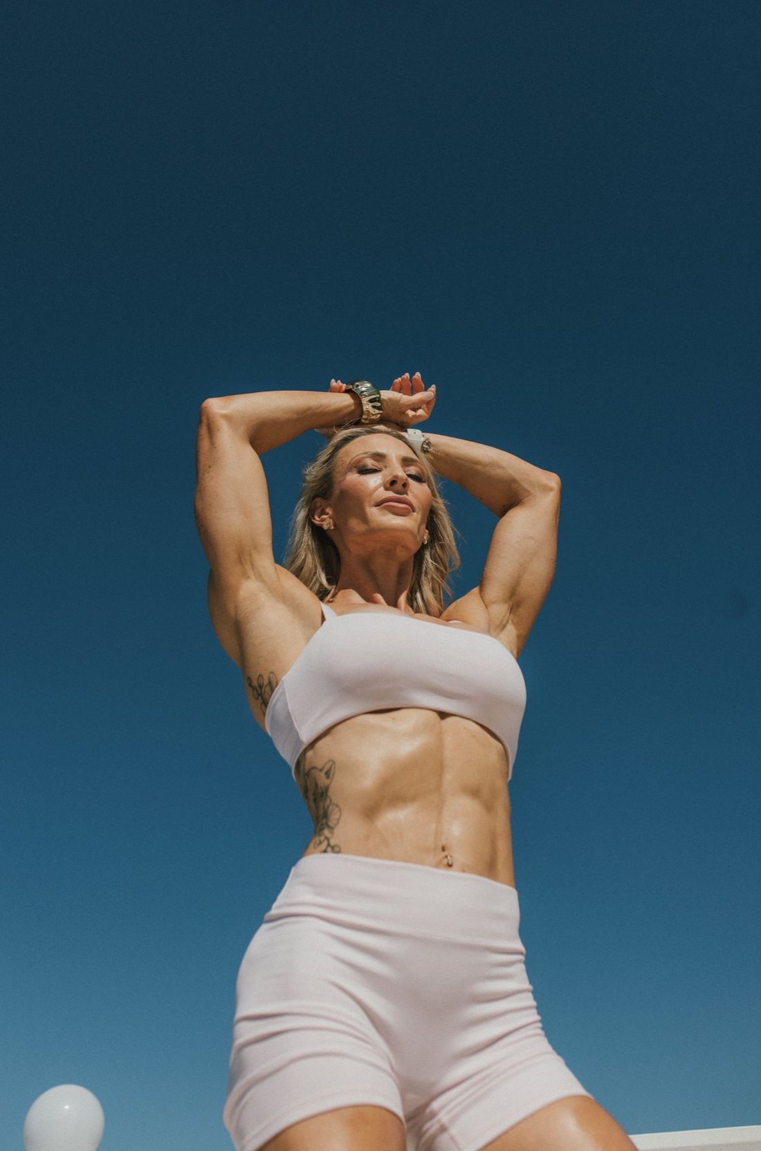 Tracey Defferrard, Figure Pro Champion and coach, against a clear blue sky