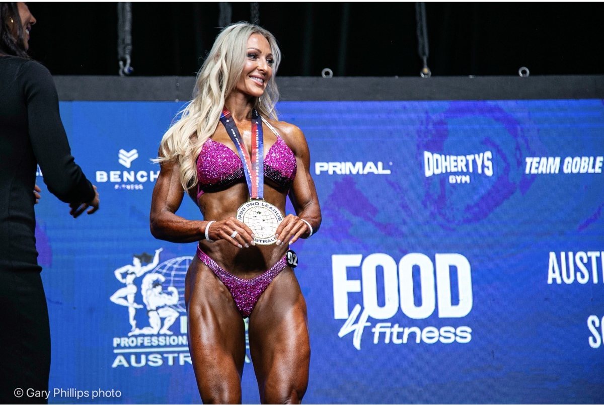 Tracey Defferrard on stage with her IFBB Pro League medal